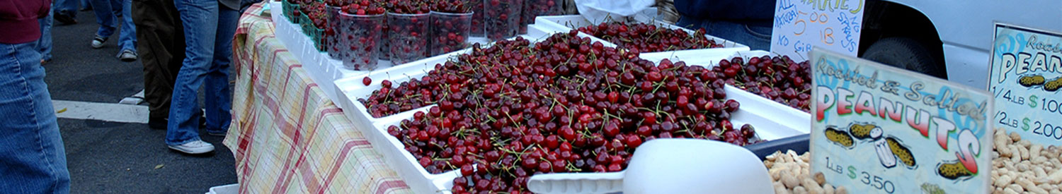 Montecito Market with a bunch of cherries for sale